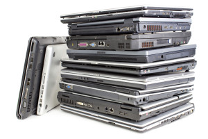 Pile of laptops *** Local Caption *** Pile uf used laptops, white background